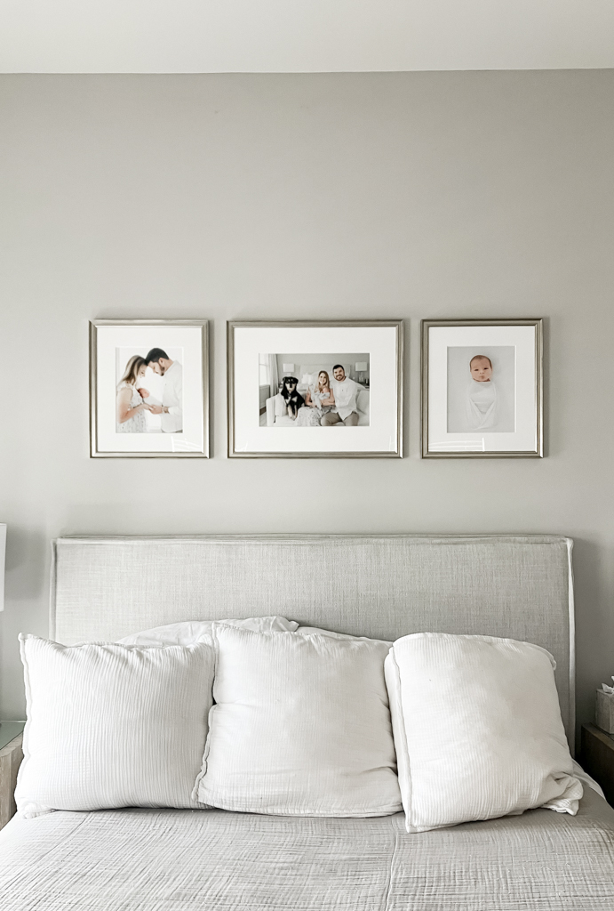 3 wall portraits hang above a headboard featuring a family's newborn photos