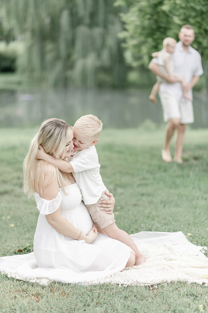 A boy hugs his pregnant mother by Franklin TN Maternity photographer Kristie Lloyd.