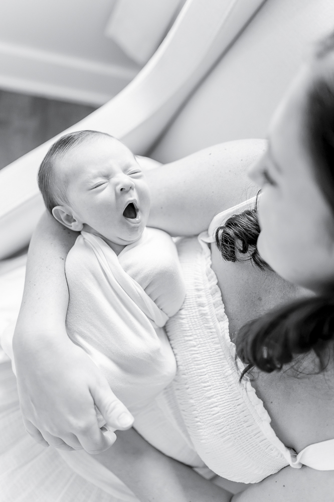 Black and white image of a newborn yawning by the best nashville newborn photographer Kristie Lloyd