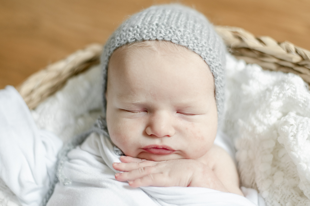 Newborn baby in a blue bonnet