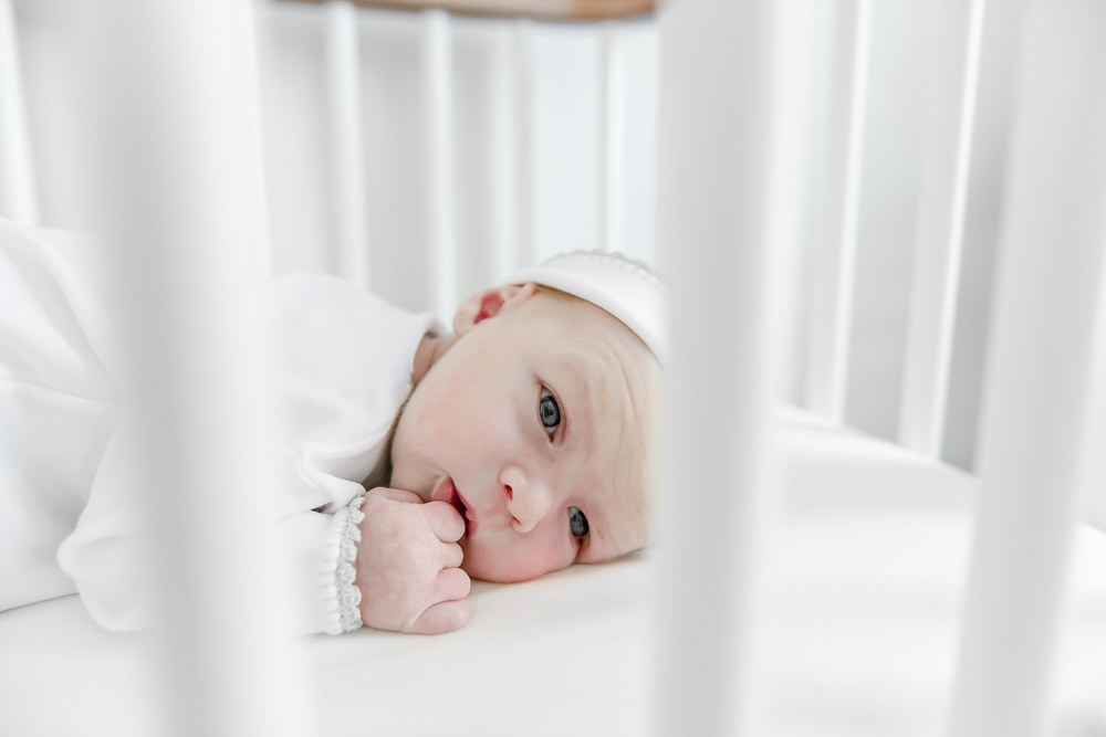 A newborn baby boy lays in his crib in his Nashville home's nursery.