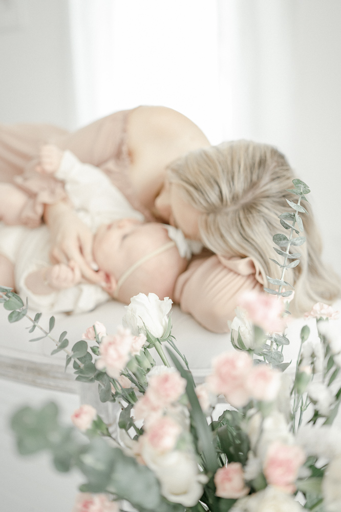 A mom cuddles with her baby in Kristie Lloyd's Franklin, TN photography studio during her mommy and me mini-session