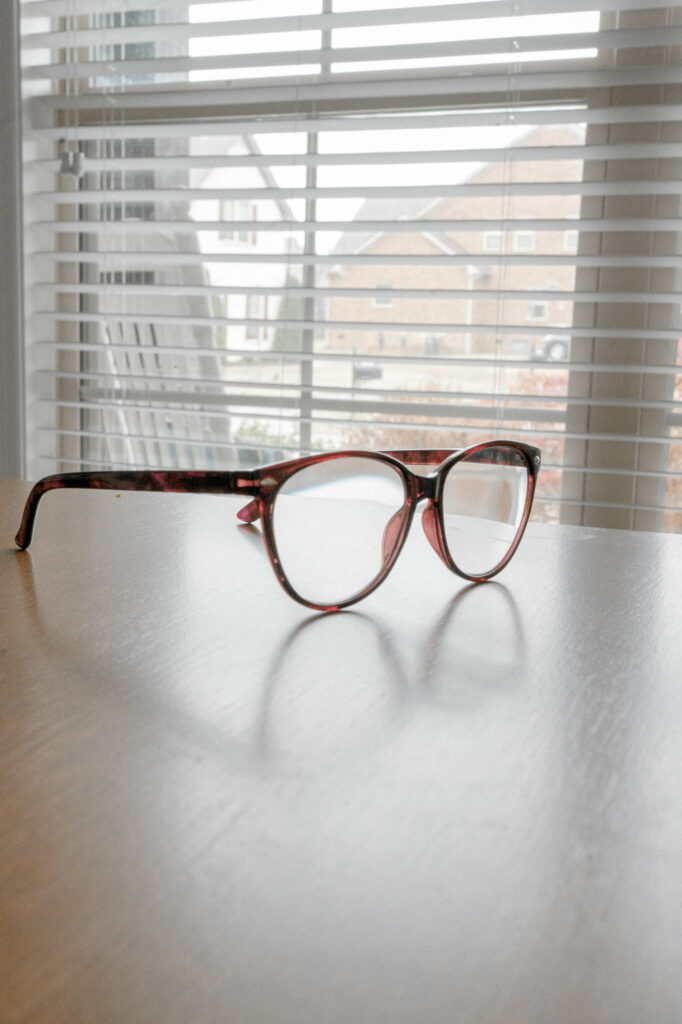 Brown glasses sit on a desk photographed with aperture at f16