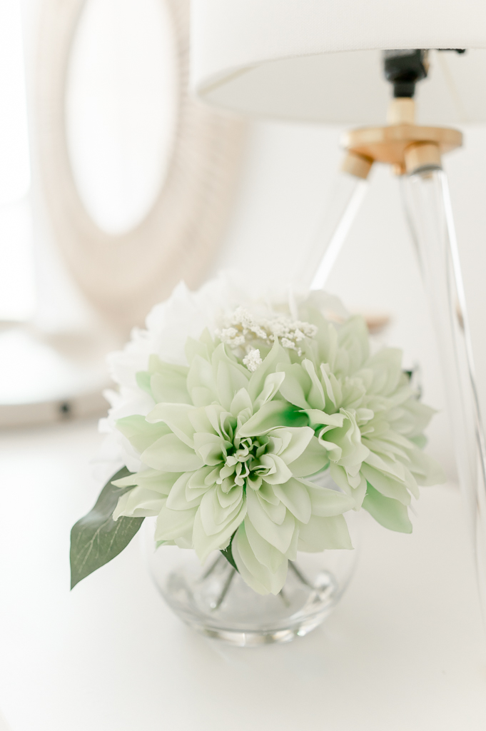 Green flowers in a clear vase