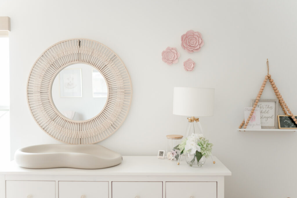 Nursery inspiration: mirror over changing table with flowers on the wall