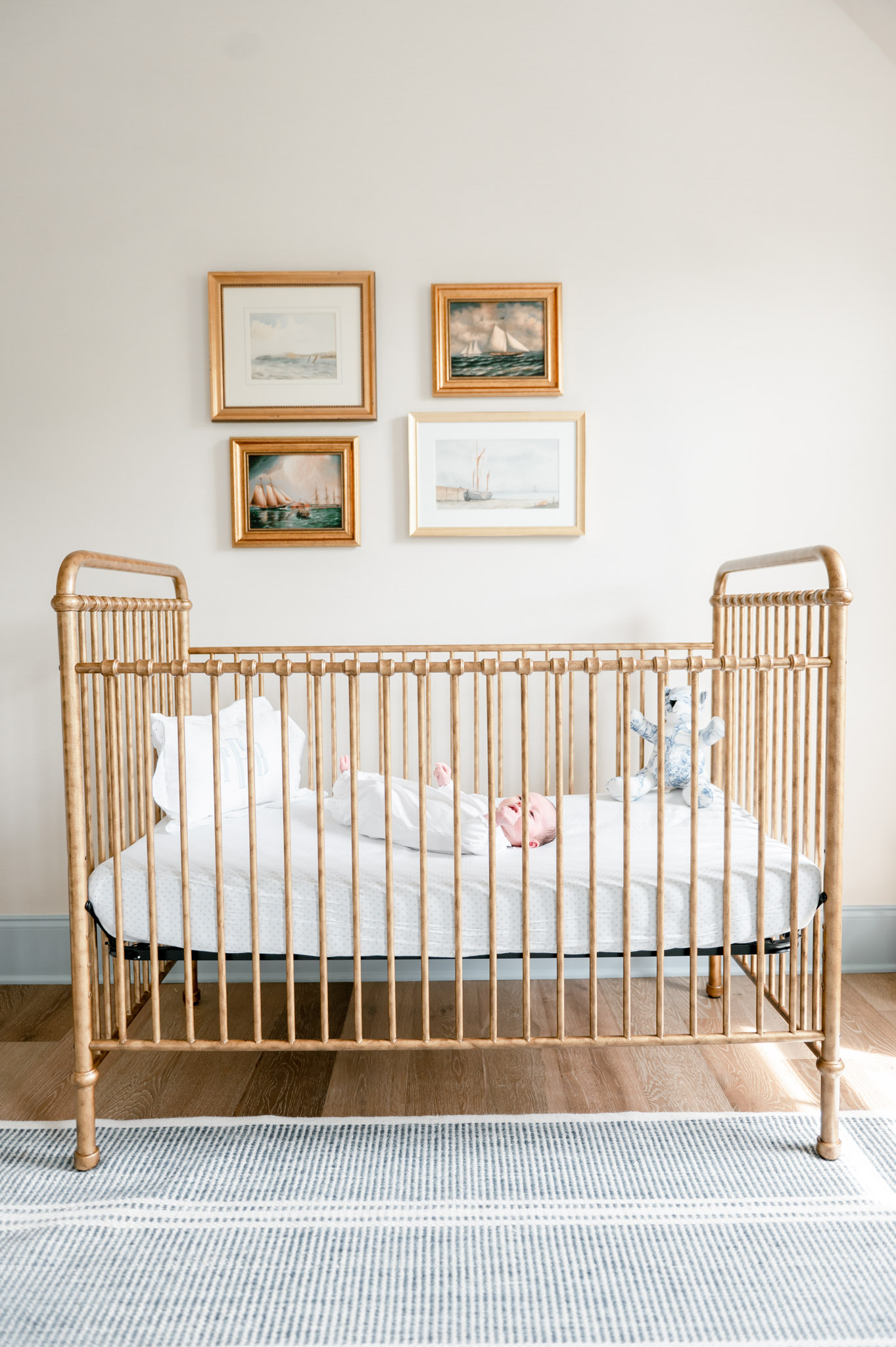 Nursery inspiration : baby boy lays in a gold crib