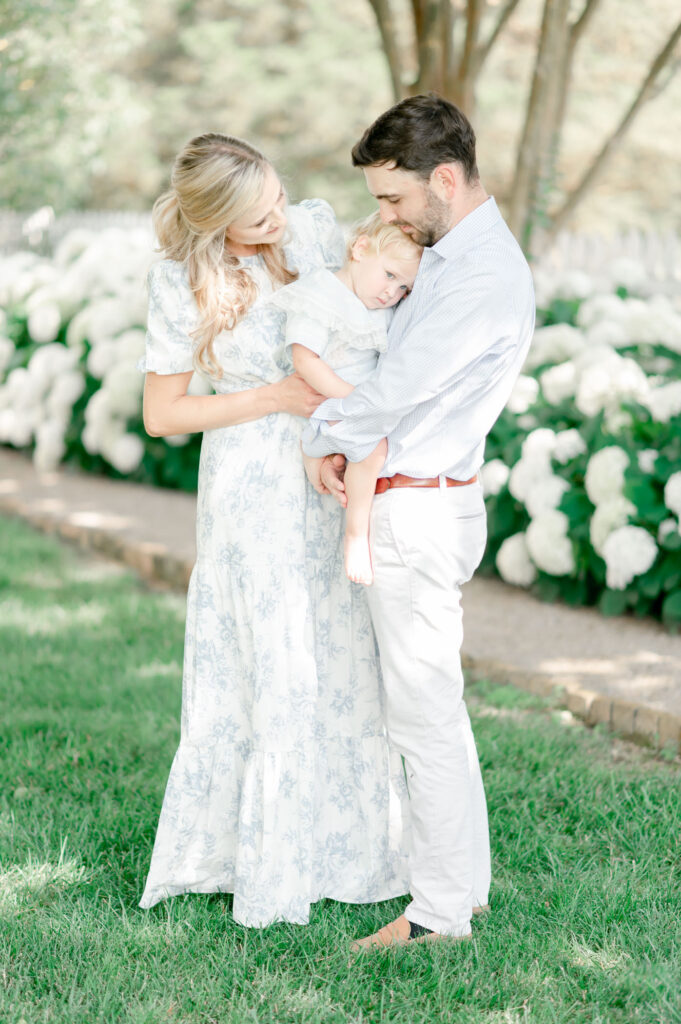 Family photos at Carnton Plantation in front of white hydrangeas by Franklin TN photographer Kristie Lloyd