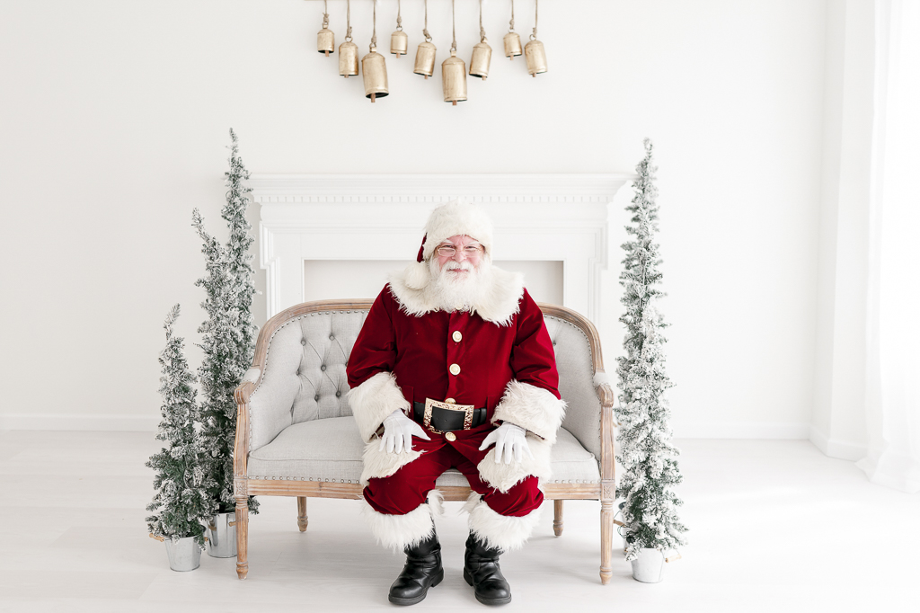 Santa Claus sits on a tufted bench in Kristie Lloyd's studio