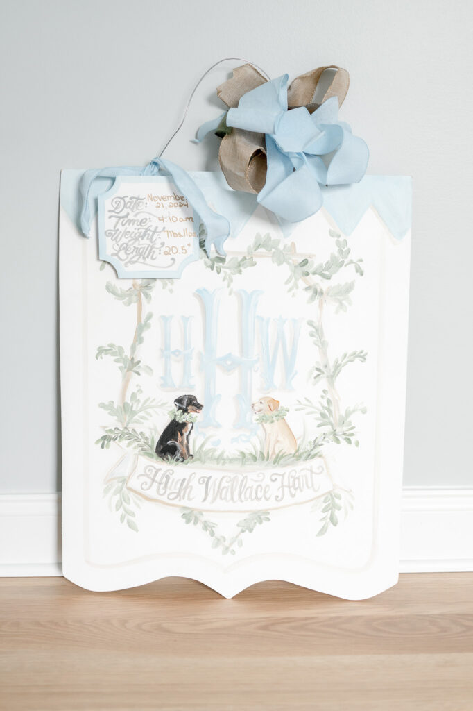 Newborn door hanger with two dogs and a blue bow